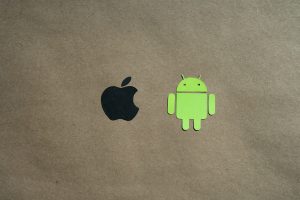 Apple logo and Android logo on a brown paper background