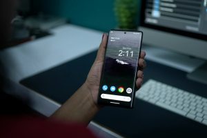 A hand holding an unlocked smartphone